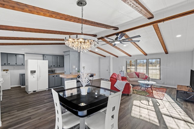 dining area featuring washing machine and clothes dryer, vaulted ceiling with beams, dark hardwood / wood-style flooring, and ceiling fan with notable chandelier