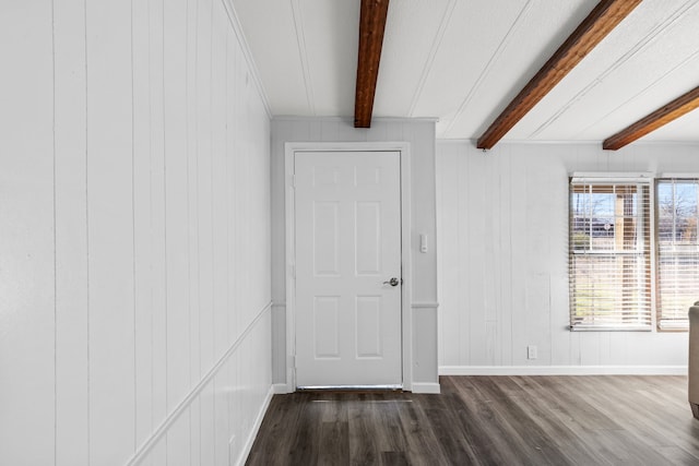 unfurnished room with beamed ceiling, wood walls, and dark hardwood / wood-style flooring