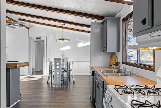 kitchen with white stove, lofted ceiling with beams, plenty of natural light, and sink