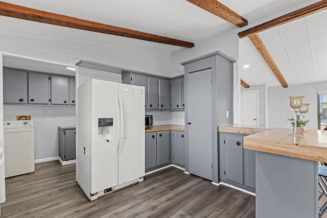 kitchen featuring kitchen peninsula, washing machine and clothes dryer, vaulted ceiling with beams, dark hardwood / wood-style floors, and white fridge with ice dispenser