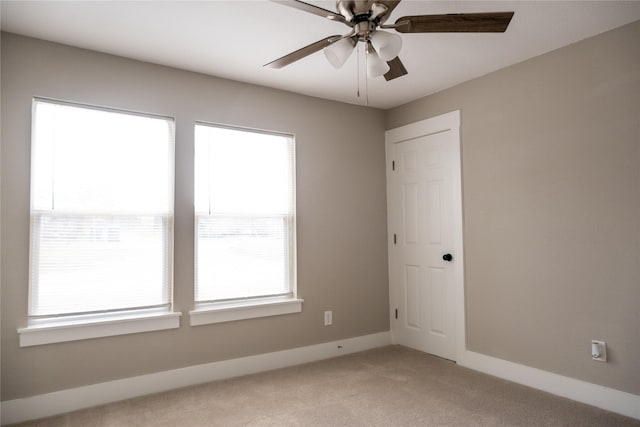 spare room featuring ceiling fan and light colored carpet