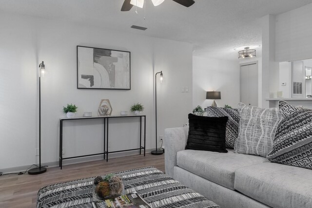 hallway featuring a chandelier, a textured ceiling, and hardwood / wood-style flooring