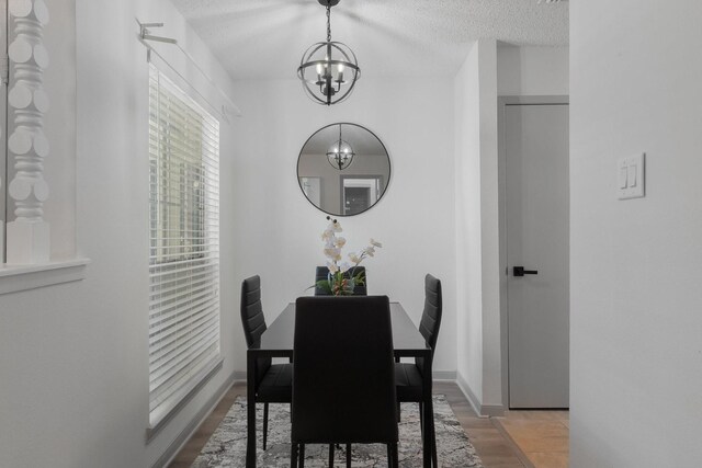 kitchen with a textured ceiling, sink, light tile patterned floors, white cabinets, and white fridge