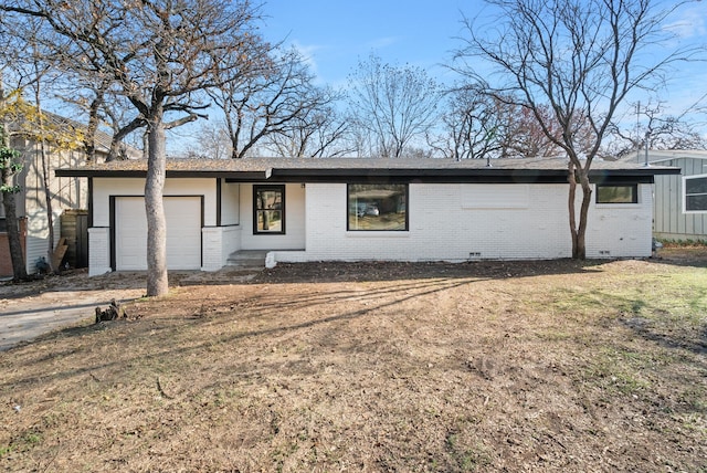 ranch-style home with a garage and a front yard