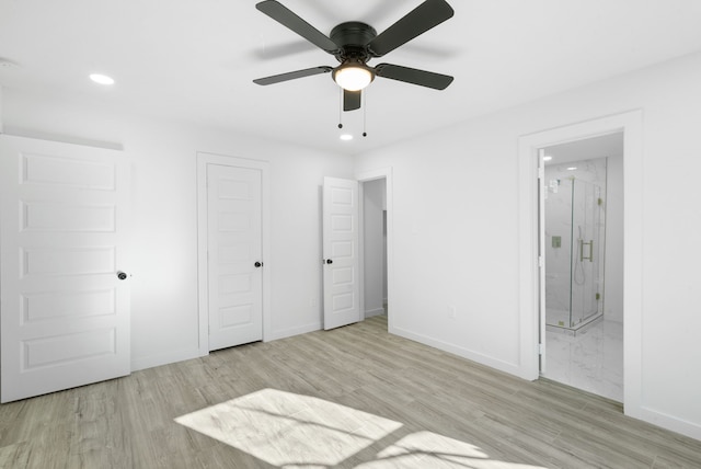 unfurnished bedroom featuring ceiling fan, light hardwood / wood-style flooring, and ensuite bath