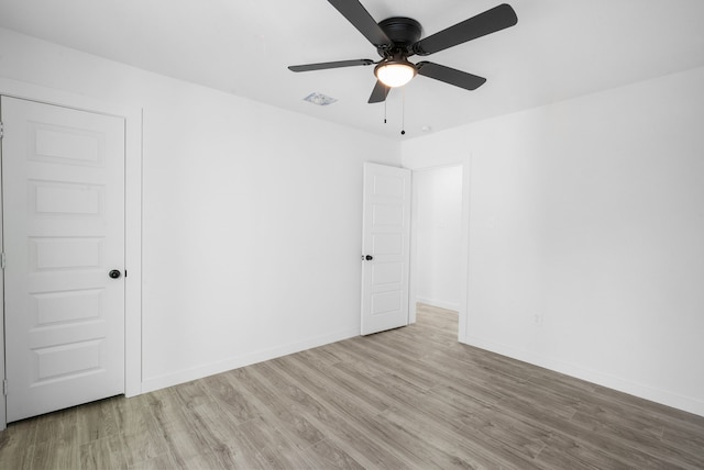 spare room featuring ceiling fan and light wood-type flooring