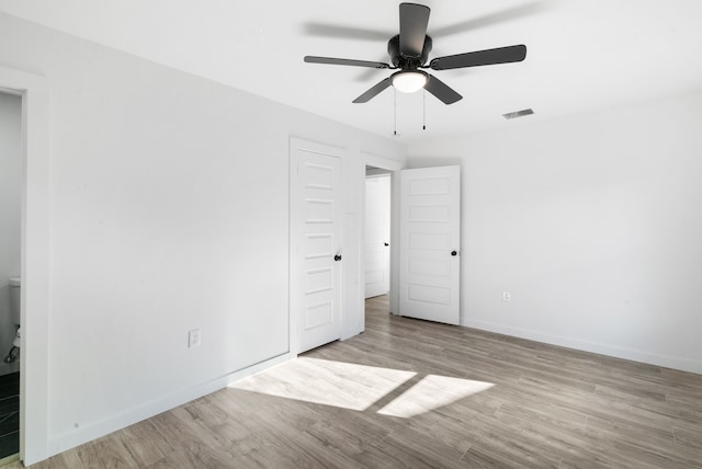 unfurnished bedroom with ceiling fan and light hardwood / wood-style floors