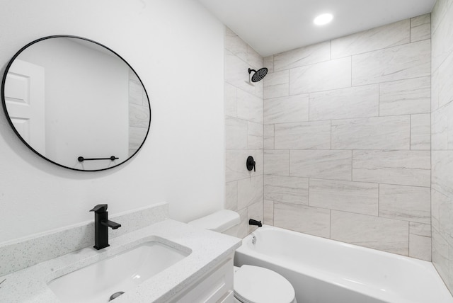 full bathroom featuring vanity, toilet, and tiled shower / bath