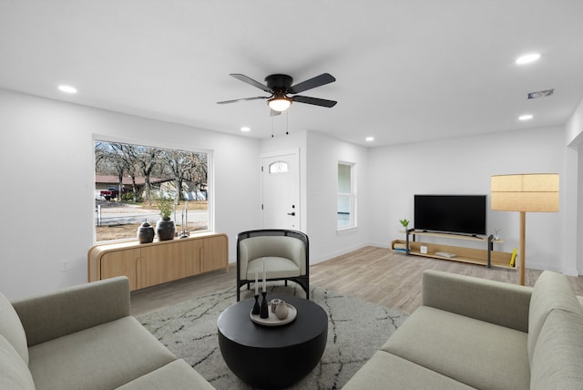 living room featuring ceiling fan and light hardwood / wood-style flooring