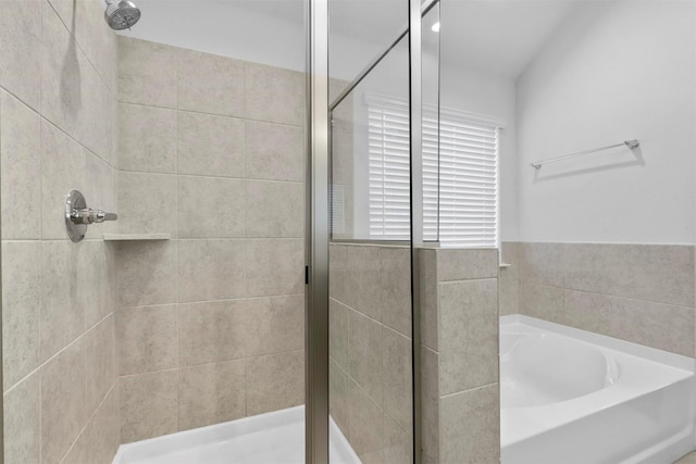 bathroom with shower with separate bathtub