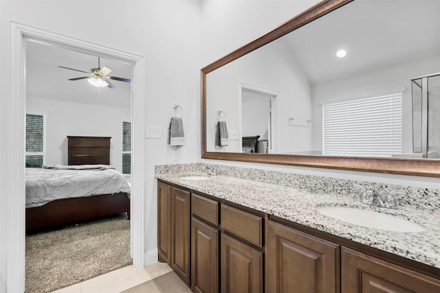 bathroom featuring vanity, lofted ceiling, tile patterned floors, ceiling fan, and a wealth of natural light