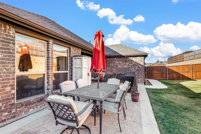 view of patio / terrace featuring area for grilling and a shed