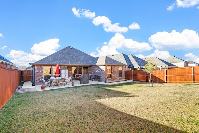 back of house with a patio and a lawn