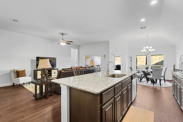 kitchen with plenty of natural light, hanging light fixtures, dark hardwood / wood-style floors, and sink