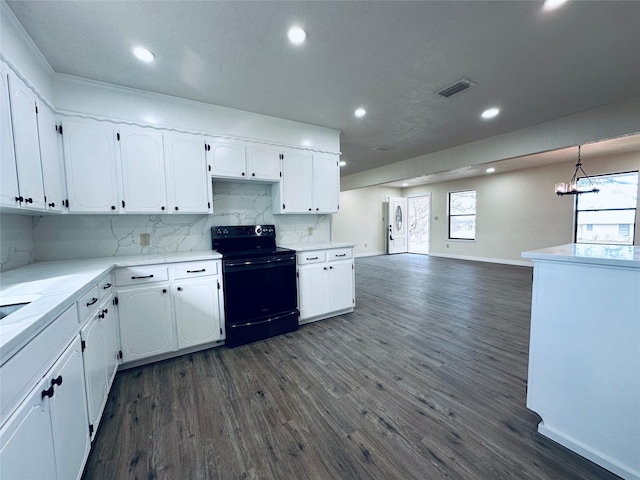 kitchen featuring dark wood finished floors, white cabinets, and black electric range oven