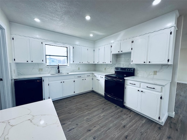 kitchen with a sink, white cabinetry, dark wood-style floors, black appliances, and tasteful backsplash