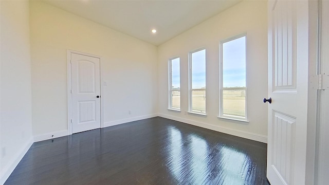 unfurnished room with dark hardwood / wood-style floors