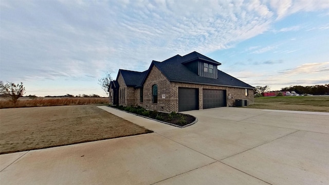 view of property exterior featuring a garage and central AC