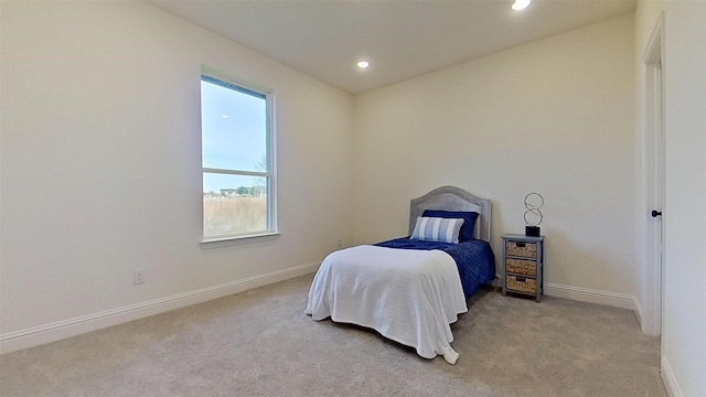 bedroom featuring light carpet