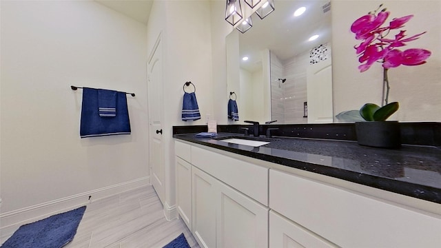 bathroom with vanity, hardwood / wood-style floors, and walk in shower