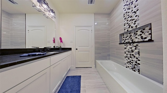 bathroom with vanity and a tub to relax in