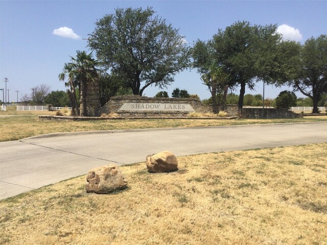 community / neighborhood sign with a lawn