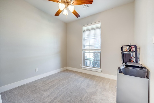 carpeted spare room with ceiling fan