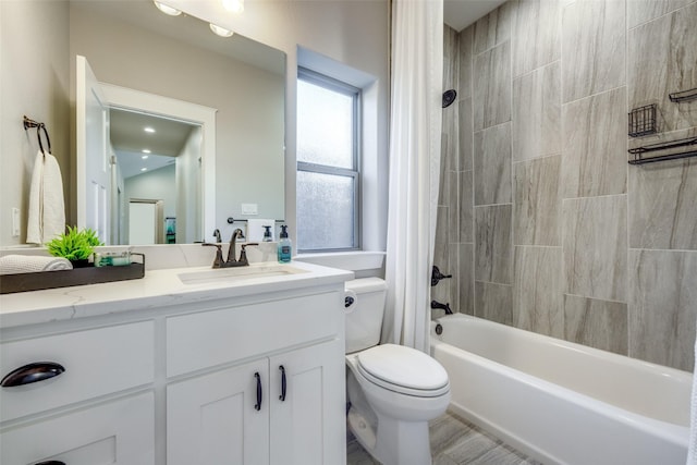 full bathroom with shower / bath combo with shower curtain, vanity, and toilet