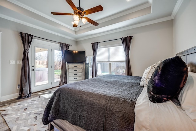 bedroom featuring light wood-type flooring, ornamental molding, access to outside, a tray ceiling, and ceiling fan