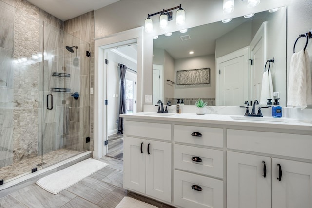 bathroom featuring vanity and a shower with shower door