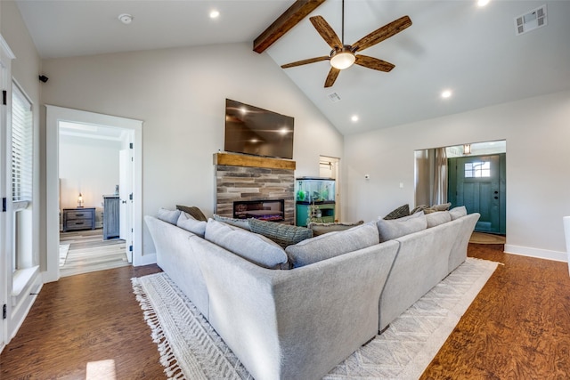 living room featuring ceiling fan, a tile fireplace, beam ceiling, hardwood / wood-style flooring, and high vaulted ceiling