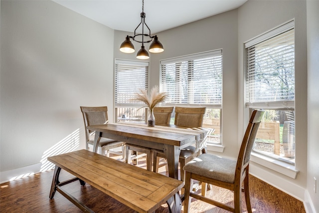 dining room with wood-type flooring and a notable chandelier