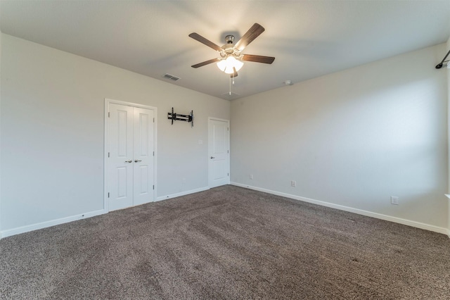 unfurnished bedroom with carpet floors, a closet, and ceiling fan