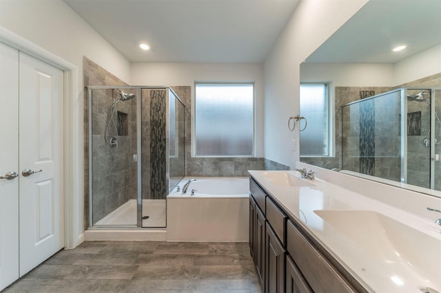 bathroom featuring vanity, wood-type flooring, and independent shower and bath