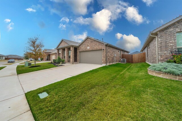 view of front of home with a garage, a front lawn, and cooling unit