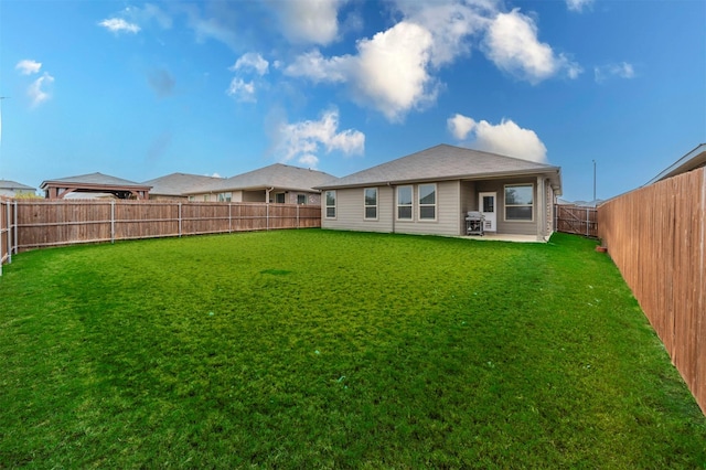 rear view of property with a yard and a patio