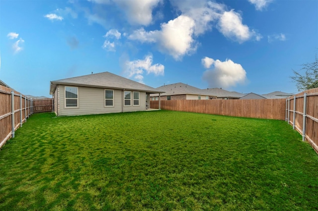 rear view of property with a lawn