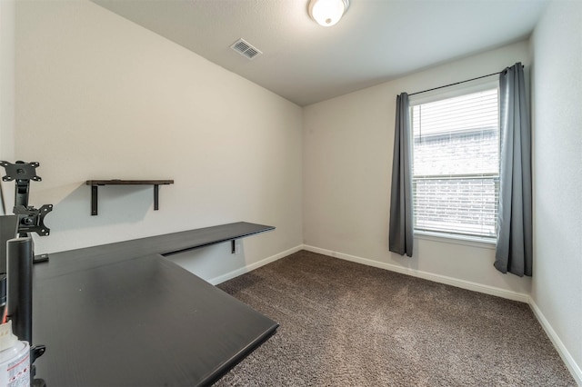 unfurnished office with dark colored carpet