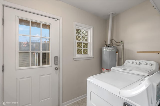 washroom with washing machine and dryer and gas water heater