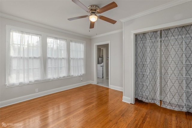 empty room with ceiling fan, a healthy amount of sunlight, and light wood-type flooring