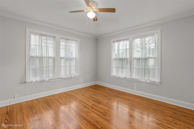 unfurnished room with ornamental molding, hardwood / wood-style flooring, ceiling fan, and a healthy amount of sunlight