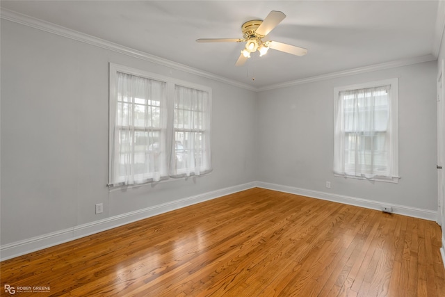 spare room with hardwood / wood-style floors, ceiling fan, and ornamental molding