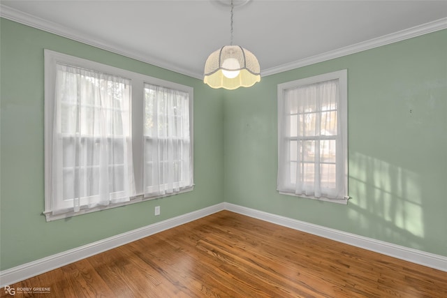 spare room featuring hardwood / wood-style floors and ornamental molding