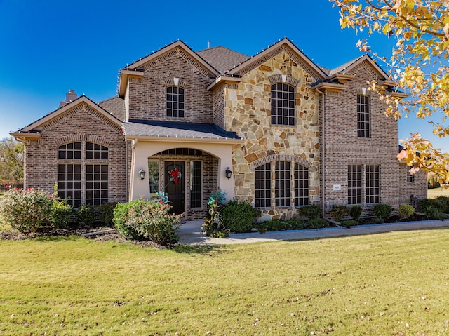 view of property featuring a front lawn