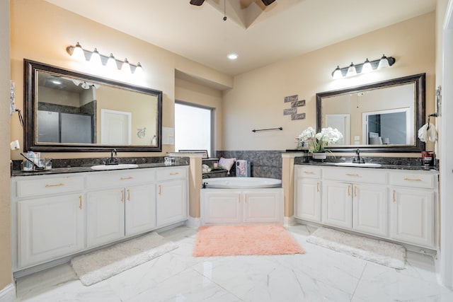 bathroom featuring a bathing tub, vanity, and ceiling fan