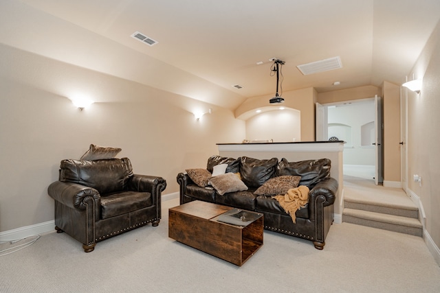 living room with carpet floors and vaulted ceiling