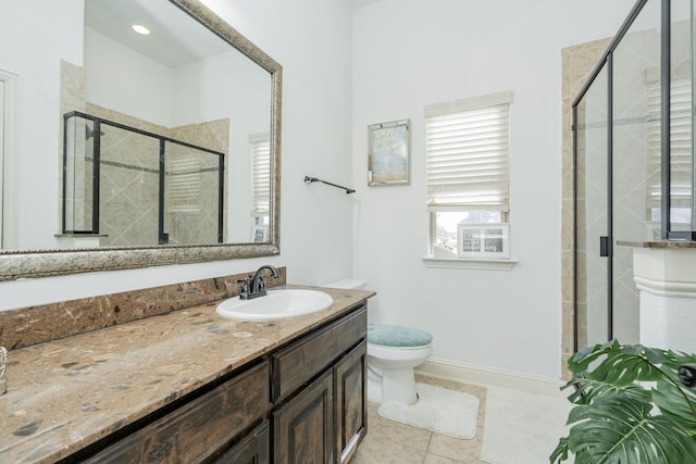 bathroom with tile patterned flooring, vanity, toilet, and walk in shower