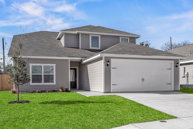 view of property with a garage and a front yard