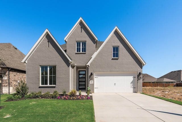 view of front of house with a garage and a front yard