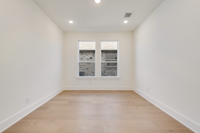 spare room with light wood-type flooring